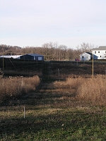  This is a view of the entire array, so far, from the southeast end, looking northwest.  The first set of vertical is 290 feet away, the second set is 580 feet away, and the third set is 870 feet away.  The right hand vertical of the second set is nearly impossible to see in this picture (even in the large version).  The right hand vertical of the third set is missing, because it broke in two.  A-frames of 2x2s are not strong enough.